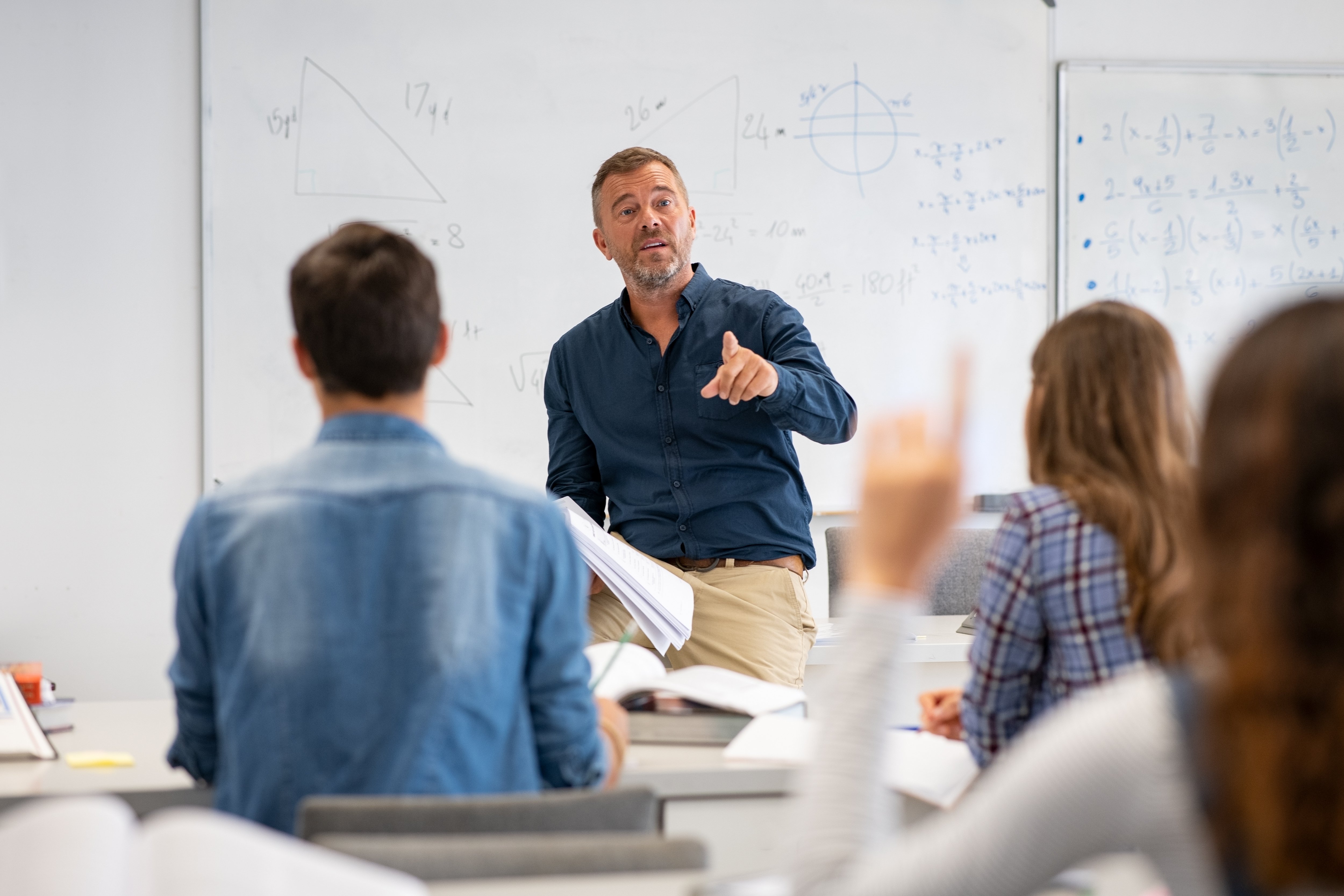 A teacher instructing a school classroom.