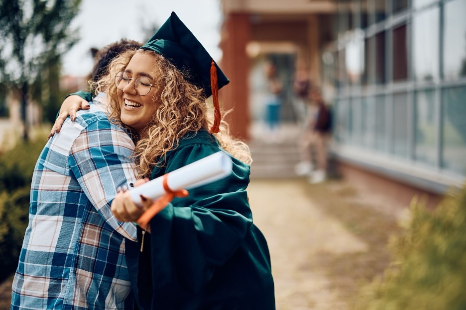 A girl hugging at graduation.