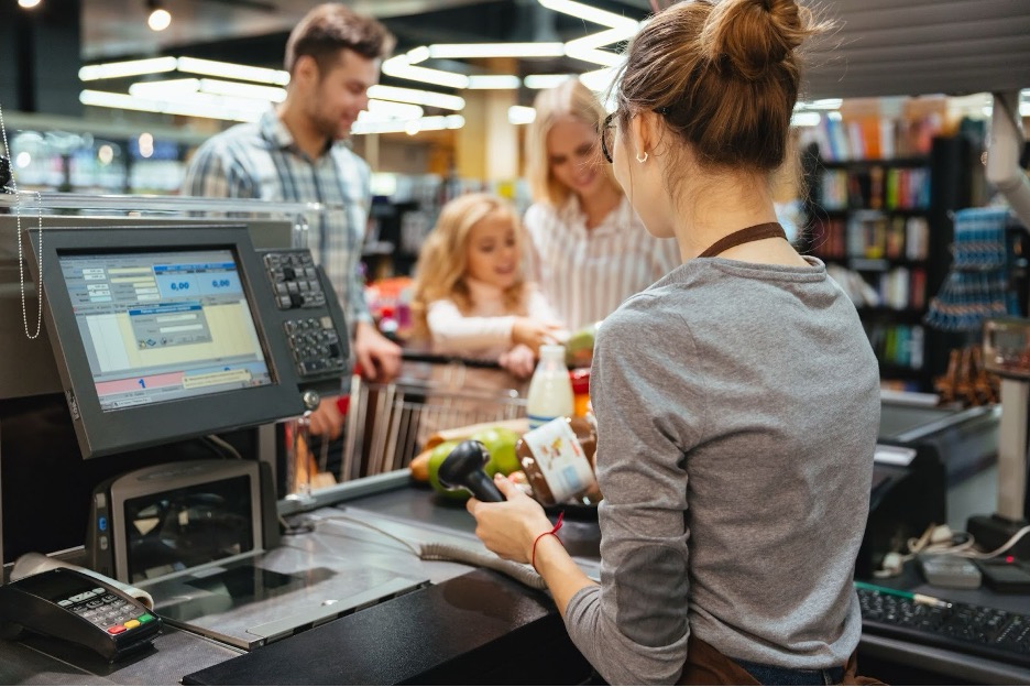 A student working in a grocery store.